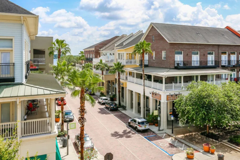 Two-story buildings with porches in walkable Florida neighborhood.